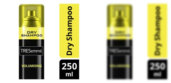 A hero image for a dry shampoo product, which contains the text ‘dry shampoo’ on the bottle, and also in a vertical strip. A visual clarity test creates a blurred version of the image, which simulates the challenges of viewing it at thumbnail size on a mobile. In this blurred version, the text in the vertical strip is considerably clearer than the same text that appears on the product.